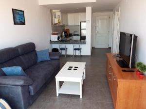 a living room with a couch and a table at Apartamento de lujo, para relajarse en Mojácar in Mojácar