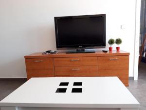 a tv sitting on top of a wooden dresser at Apartamento de lujo, para relajarse en Mojácar in Mojácar