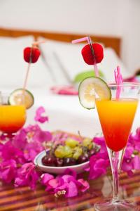 a table with two cocktails and a plate of food at Kekova Hotel in Kaş