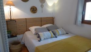 a bedroom with a bed with pillows on it at Gîte Marius in Mirabel-aux-Baronnies