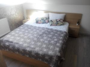 a bedroom with a bed with two pillows on it at A. Einstein 9A Apartament in Cluj-Napoca