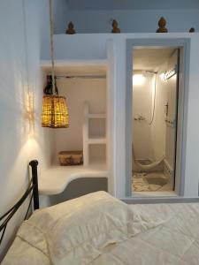 a bedroom with a glass window with a shower at Dreamcatcher of Zeus in Philotium