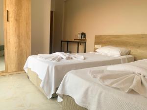 Letto o letti in una camera di Kaizen Gate Hotel