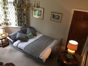 a bedroom with a bed with pillows and a window at Fernbank Suite in Sheffield