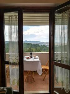 a view from the balcony of a house with a table at Casa Alice in Camigliatello Silano