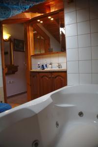 a white bath tub in a bathroom with a sink at Stathoula's House in Kontokali