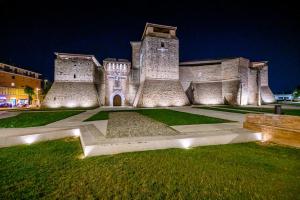 a large building with lights in front of it at Hotel St Gregory Park in Rimini