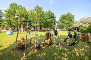 a group of children playing on a playground at Hotel St Gregory Park in Rimini