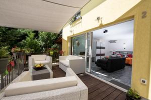 a patio with white furniture on a deck at Apartment Gala Opatija in Opatija