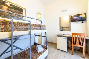 a room with a bunk bed and a desk at Hotel St Gregory Park in Rimini