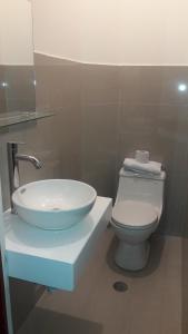 a bathroom with a sink and a toilet at Kantu Progreso Inn in Cusco +28 photos