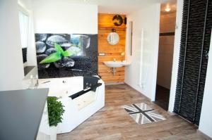 a bathroom with a white tub and a sink at Gasthof Alpenblick in Sierning