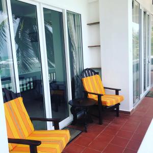 two chairs and a bench on a porch at La Veranda Di Serena in Unawatuna