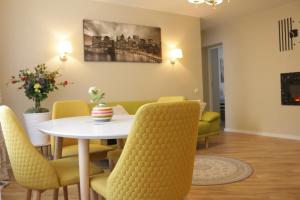 TIP TOP في شياولياي: غرفة طعام مع طاولة بيضاء وكراسي صفراء