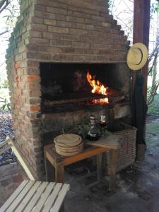 a brick fireplace with a table in front of it at Quinta en Pilar in Del Viso