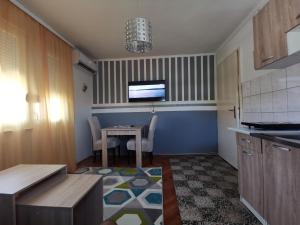 a kitchen with a table and a dining room at Apartment I&M Capljina in Čapljina +4 photos
