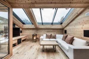 a living room with a white couch and a tv at Chalet Ourtls Pärg in Solda