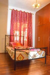 a bed sitting in a room with a window at Vieri apartments in Lukovë +50 photos