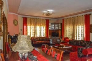 a living room with red couches and a table at Vieri apartments in Lukovë
