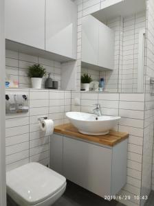 Baño blanco con lavabo y aseo en Gdynia ul.Chopina 11/25 Apartament nad morzem, en Gdynia