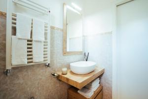 a bathroom with a sink and a mirror at Chez Lia - Private garden and tub, sea view close to Villa Eva and Cimbrone, Ravello in Ravello