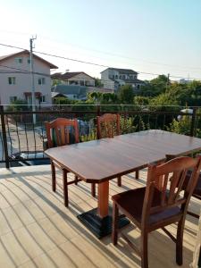 a wooden table and chairs on a deck at ROMSIL GUESTHOUSE in Costinesti