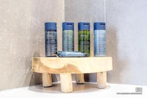 a wooden shelf with four liquids on it at Senso Suites in Nea Peramos