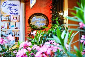 a sign on the side of a building with pink flowers at Gedikpasa Konagi Hotel in Istanbul