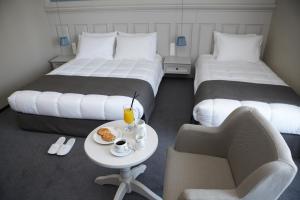 Postel nebo postele na pokoji v ubytování Rodopi Hotel