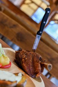 a steak on a cutting board with a knife at Hotel Jelen in Hlohovec