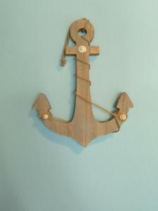 a wooden anchor hanging on a wall at Apartments Sandra in Lopar