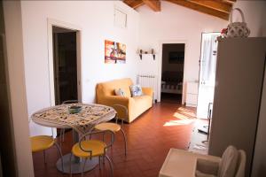 a living room with a table and chairs and a couch at Casa Cinzia Bonassola Cinque Terre in Bonassola