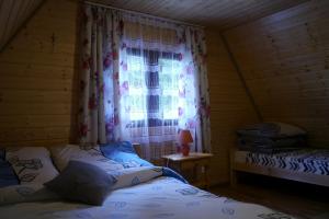 a bedroom with two beds and a window at Leśniakówka 693-664-683 in Solina