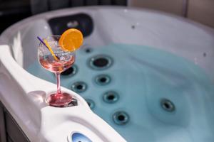 a glass of wine sitting on the edge of a bath tub at Apartment Velvet in Dubrovnik