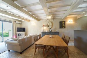 a living room with a table and a couch at Les Restanques De Beaudine in Forcalquier
