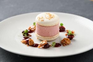 a pink and white dessert on a white plate at The Bell at Ramsbury in Marlborough