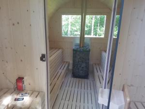 an inside view of a sauna with a window at Agro Breza domek nad samym jeziorem- sauna, balia ogrodowa in Lipusz