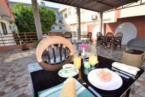 a table with food and drinks on a patio at B&B Chez Rita in Cotonou