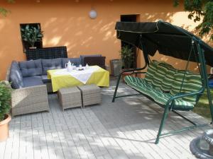 a patio with a couch and a table and chairs at Pension Jana Tatrovice in Tatrovice