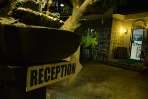 a sign that says evacuation sitting next to a tree at Bodrum Park Hotel in G&uuml;mbet