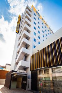 a hotel building with a sign on top of it at Super Hotel Tokyo JR Shinkoiwa in Tokyo