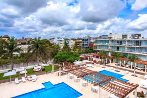 an aerial view of the pool at a resort at Magia Beachside Apartment by BVR in Playa del Carmen