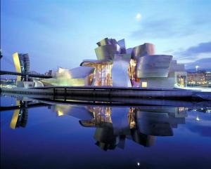 a view of a building with its reflection in the water at Casa Narolai in Bilbao