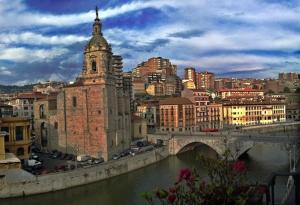 a view of a city with a bridge and a building at Casa Narolai in Bilbao