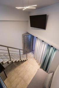 a view of a staircase with a flat screen tv at Mr & Mrs K Lofts in Potos