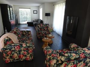 a living room with two couches and a table at Holiday Home Zeewolde in Zeewolde