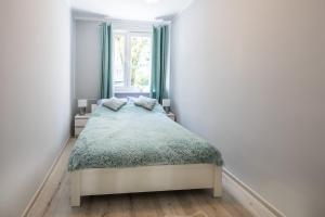 Posteľ alebo postele v izbe v ubytovaní Apartament uJasia