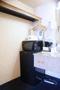 a kitchen with a microwave and a counter top at Days Inn by Wyndham Arlington Pentagon in Arlington