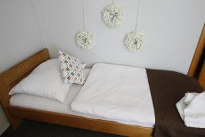 a bed in a room with wreaths on the wall at Willa Scandia in Duszniki Zdrój
