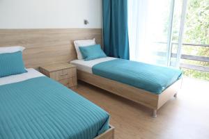 a bedroom with two beds and a window at Hotel Hijata in Stara Zagora